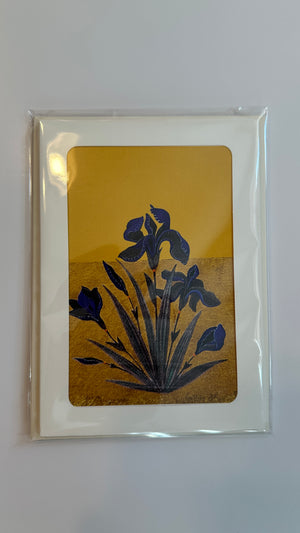  A luxury greeting card from the GC01 Iris set featuring an original art print of dark blue irises against a gold and mustard yellow background, inspired by South Asian miniature painting.
