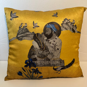 Premium quality gold poly silk Mughal art cushion cover showcasing a contemporary Mughal miniature painting of a prince and princess surrounded by birds and peacocks.