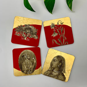 Four artistic tabletop hand-painted coasters scattered at different angles to show the fine brushwork of Mughal royal figures and botanical motifs.