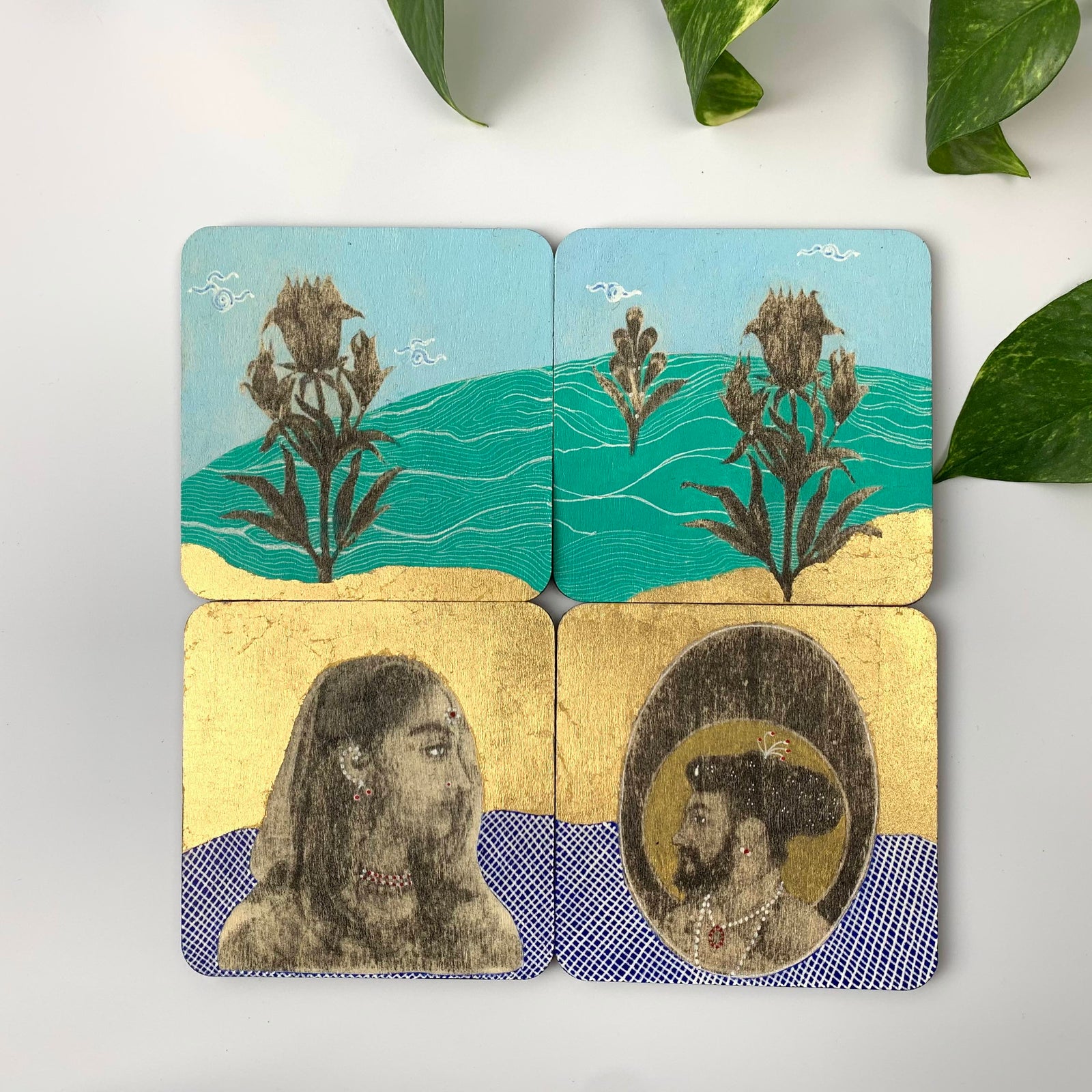 A set of four hand-painted coasters featuring Mughal miniature art with gold leaf accents and traditional royal figures.